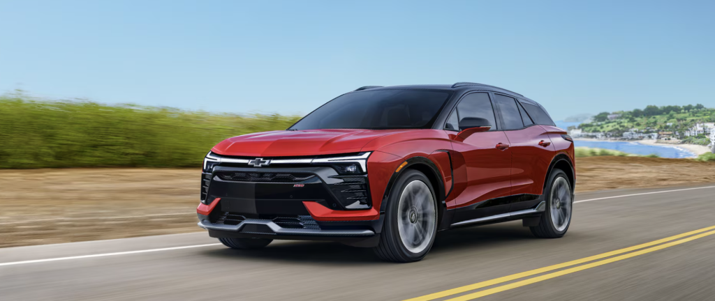 A 2026 Chevrolet Blazer EV driving down a riverfront road in Akron, OH