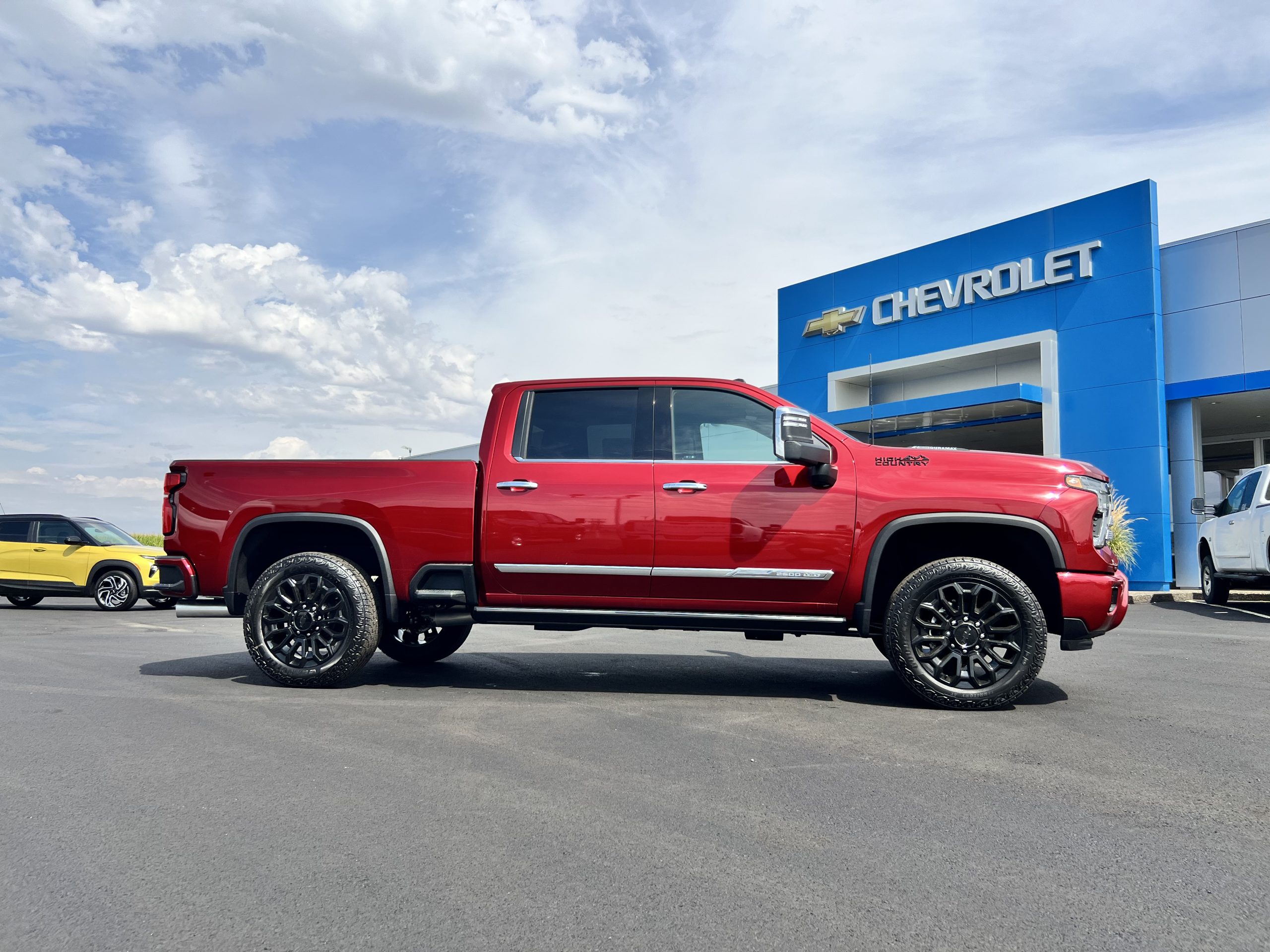 Red Chevrolet Silverado 2500 outside dealership building