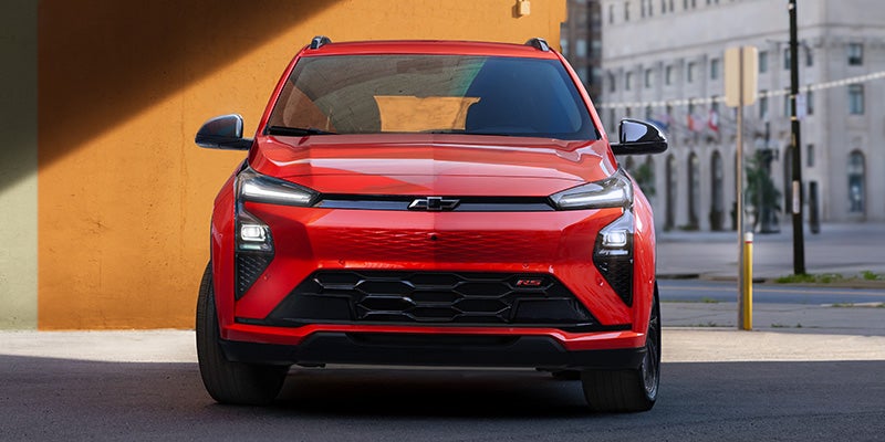 Red Chevrolet SUV front view in city setting